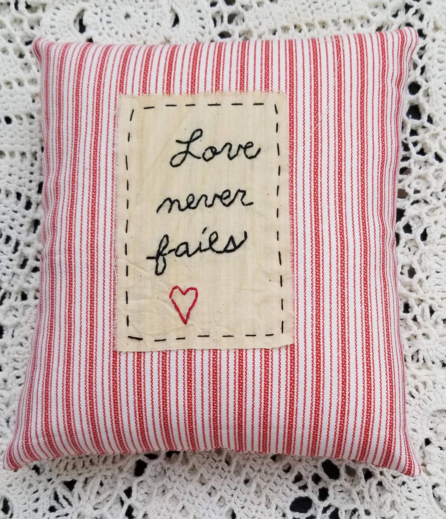 Love Never Fails Small Pillow - The Mirrored Past